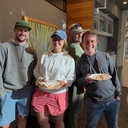 a group of people eating pizza