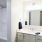 Large well lit bathroom with white accents 