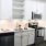 Spacious and well lit kitchen with wood flooring and stainless steel appliances