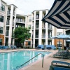 Large sparkling blue pool with a large pool deck and lounge chairs