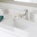 Large well lit bathroom with white accents 