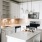 Spacious and well lit kitchen with wood flooring and stainless steel appliances