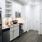 Spacious and well lit kitchen with wood flooring and stainless steel appliances